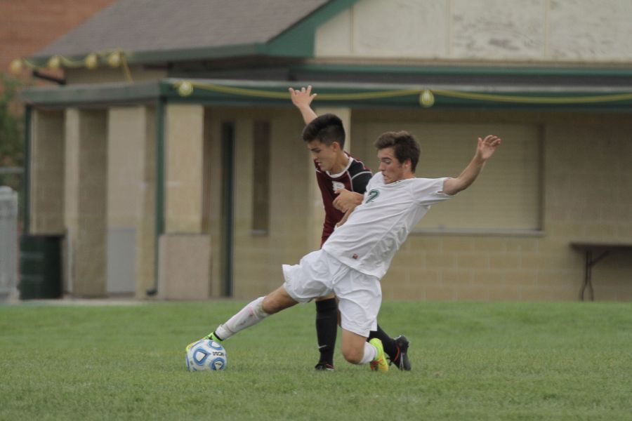 Junior Jarod Petrovic slides to keep the ball from a Plainfield North opponent. 