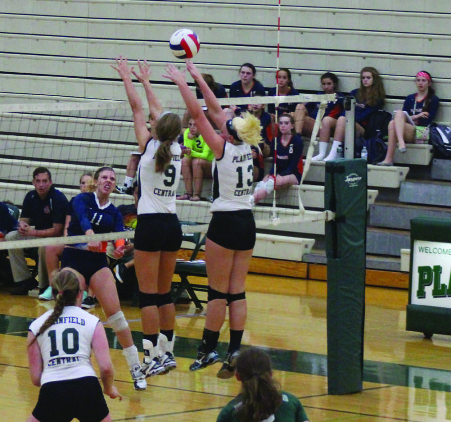 Juniors Ashley Shook and Kory Beard block a spike from Oswego East.