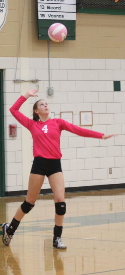 Sophomore, Grace Brock serves the ball in a win against Minooka.