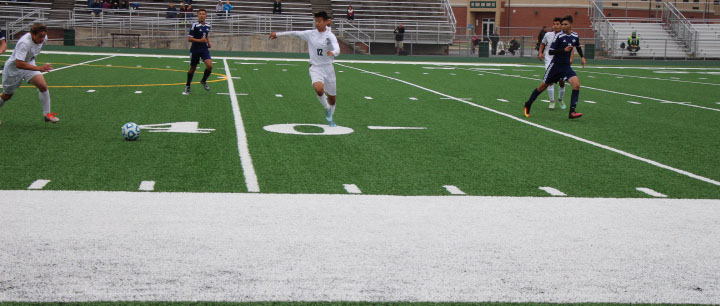 Sophomore+Sebastian+Contreras+kicks+the+ball+past+defenders+in+their+win+vs.+Plainfield+South+on+October+15.