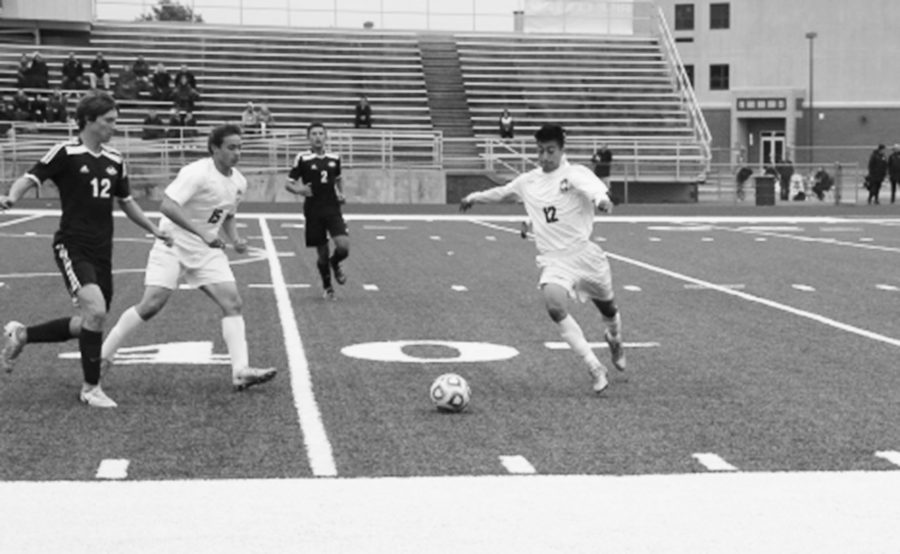 Sophomore Sebastian Contreras kicks the ball past defenders in their win vs. Plainfield South on October 15.