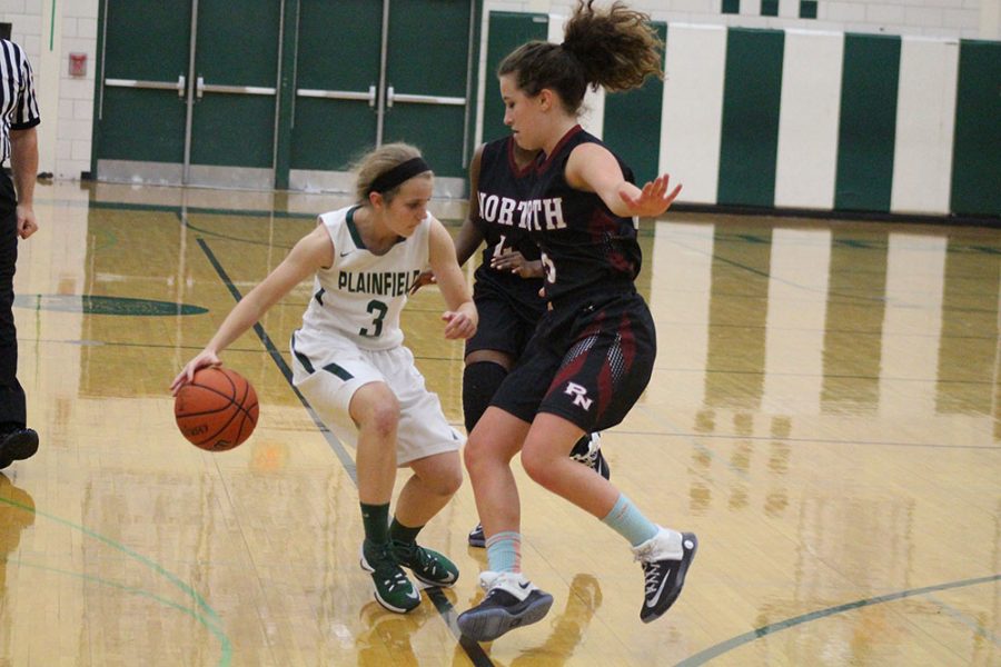 Kayley Grabowski, senior, drives around Plainfield North defenders on Dec. 6.