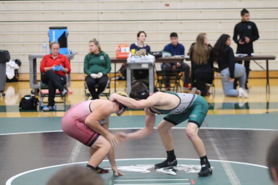 Joshua Mackenzie, junior, tries to take down his opponent in the tournament against Plainfield North on Dec 1