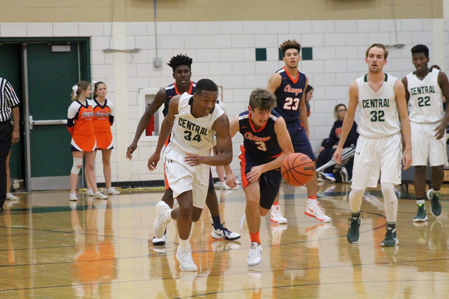 Michael Hood, senior, competes for the basketball against Oswego on  Dec. 2.
The team went on to  lose by a close score of  50  to  46.