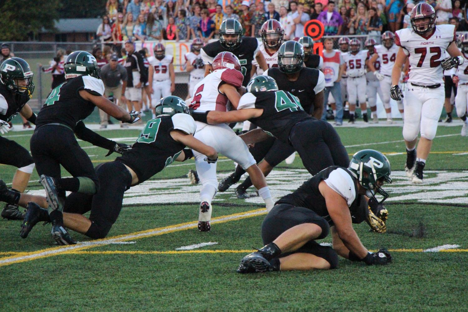 Ethan Dominguez, junior,  makes a succesful tackle against Plainfield North’s player in their first game on Friday,  Sept. 1.  The wildcats lost 7-21.