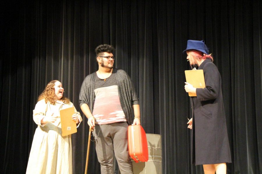  Seniors Brittney Ebner, Americo Allen Garcia and  Mikayla Icenogle, rehearse the iconic scene where Kris Kringle is hired to be the Macy’s Santa Claus in “Miracle on 34th Street.“ 