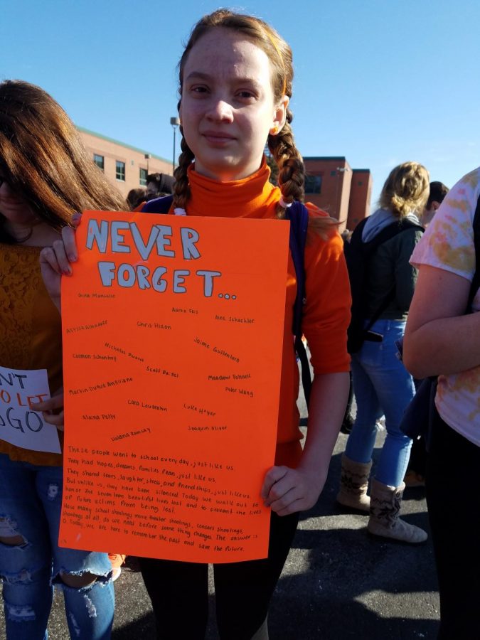 A student holds a sign in remembrance of the Parkland victims.