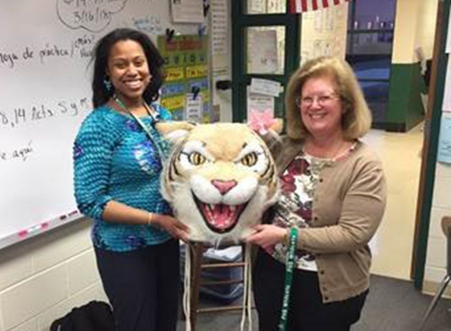 Lynn Bond, math teacher, passes Willy to Xiomara Cole, Spanish teacher.