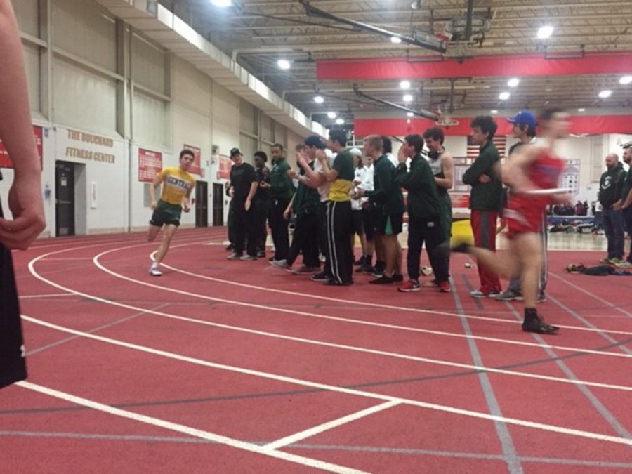 The track team cheers on teammate Brayden Ruland, freshman, as he runs the 4 by 4 relay at the Hinsdale Central meet on Mar. 2.