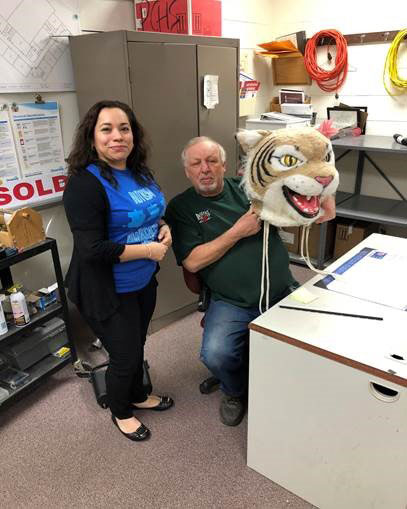 Sarah Cammack passes the Wildcat head to custodian Jeff Pesevanto.