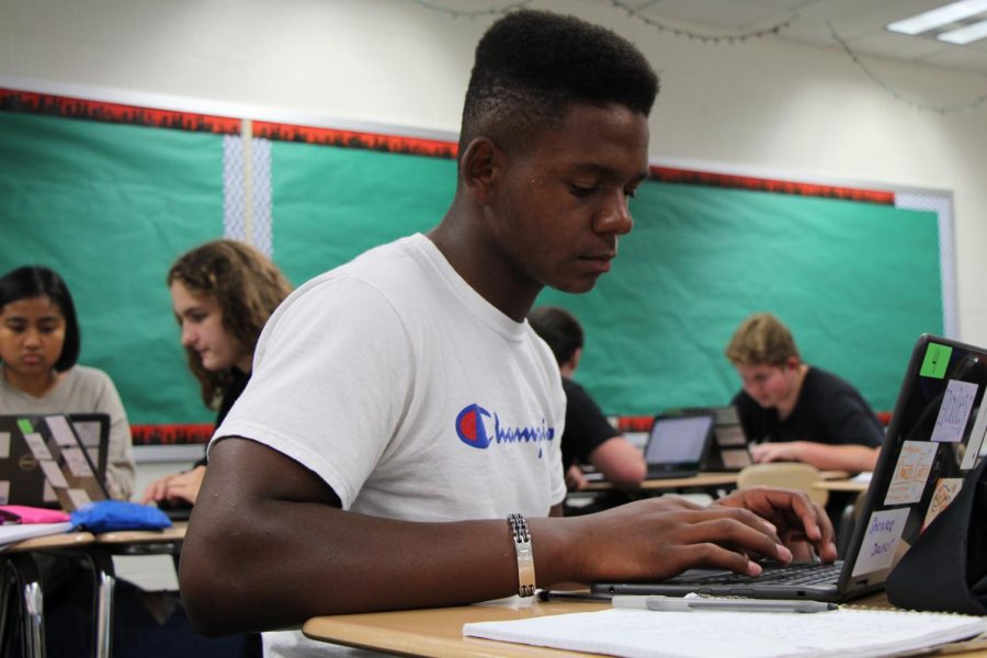 Daniel Carter, senior, works with one of the new laptops to analyze an article for his rhetoric class.