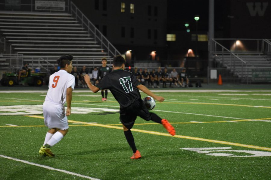  Sophomore Berto Centeno steals the ball from the Romeoville player in their 1-0 victory on Oct. 9.
