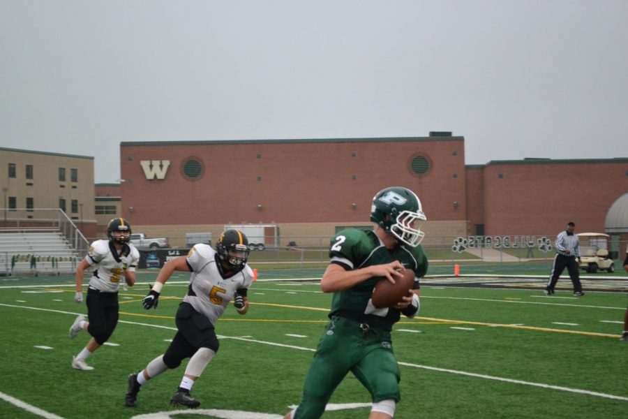 JV Quarterback Nathan Buchan, sophomore, looks for an open receiver.
