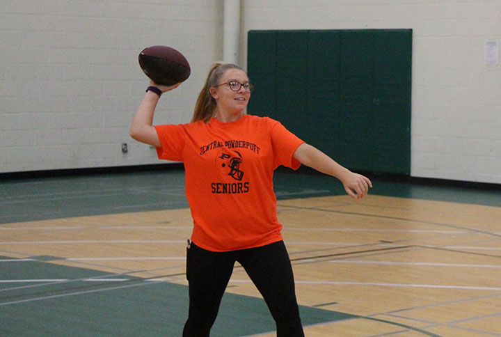 Senior Jianna Bocconcelli throws a football for her PE class. Students also have the opportunity to participate in Fit Club on Tuesdays and Thursdays to try out different activities and sports.