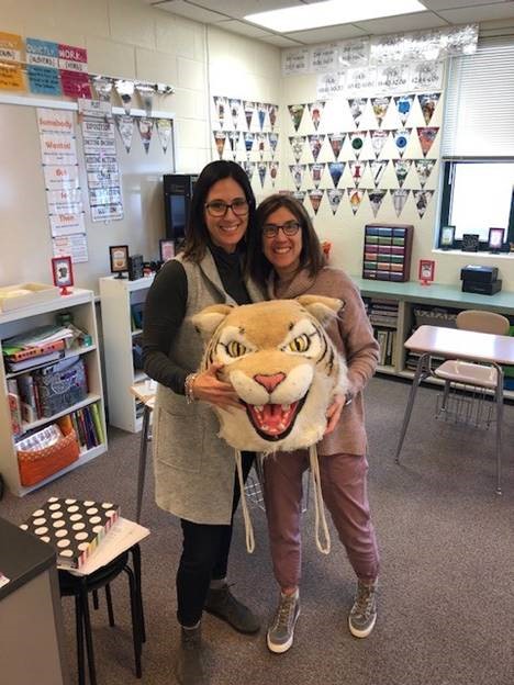 Julie+Banholzer%2C+counselor%2C+passes+the+Wildcat+award+to+Karen+Seeberg%2C+ELL+teacher.