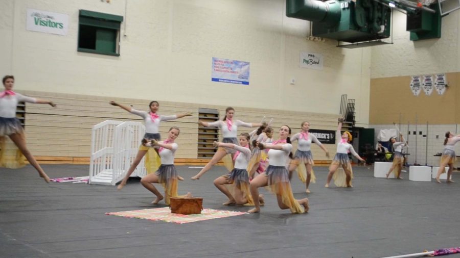 Members of Downers Grove North winter guard perform their routine in the main gym on Sunday, Feb. 3rd for the winter guard festival. 