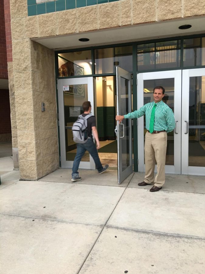 Principal Dave Stephens greets students to start his day. Many appreciate the little things Stephens does to improve the school’s atmosphere.