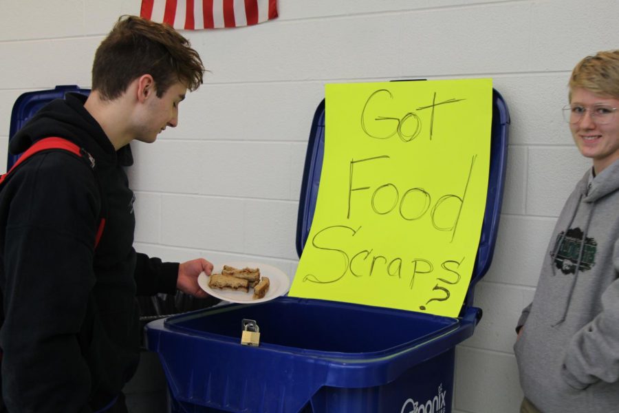 Senior+Cole+Schreiber+deposists+his+food+scraps+in+the+compost+bin.+Only+two+of+the+four+Plainfield+high+schools+are+participating+in+the+pilot+program.