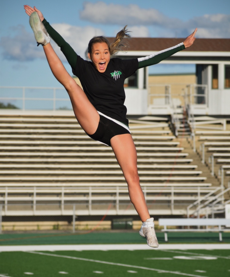 Brielle+Kerzich%2C+senior%2C+flies+above+the+stands+during+her+cheer+routine.+