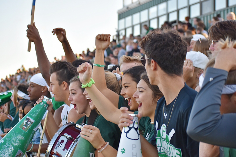 Students+cheer+on+the+football+team+as+they+play+a+game+of+scrimmage.+