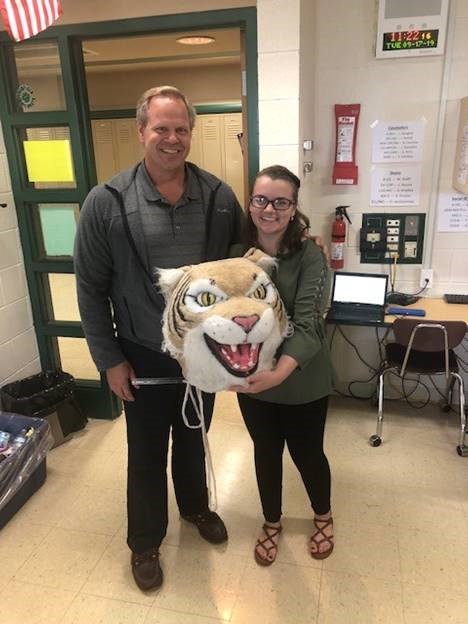 Josh Bloodgood, Catalyst director, passes the Wildcat Award to Nicole Jeffery, teacher.