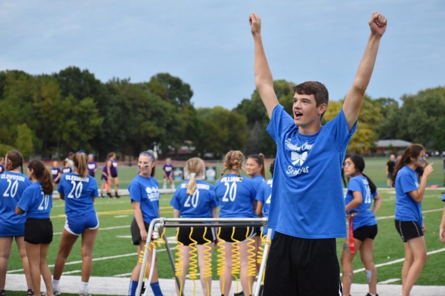 Connor Elens, senior, cheers on his fellow classmates, as boys are cheering for the girls playing football. 