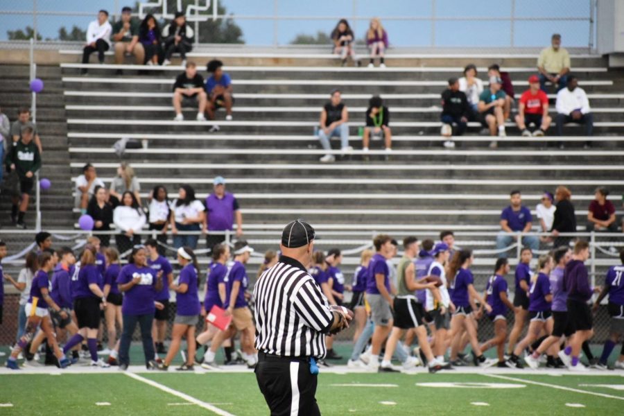 Juniors in purple can be seen behind the referee in between plays. 