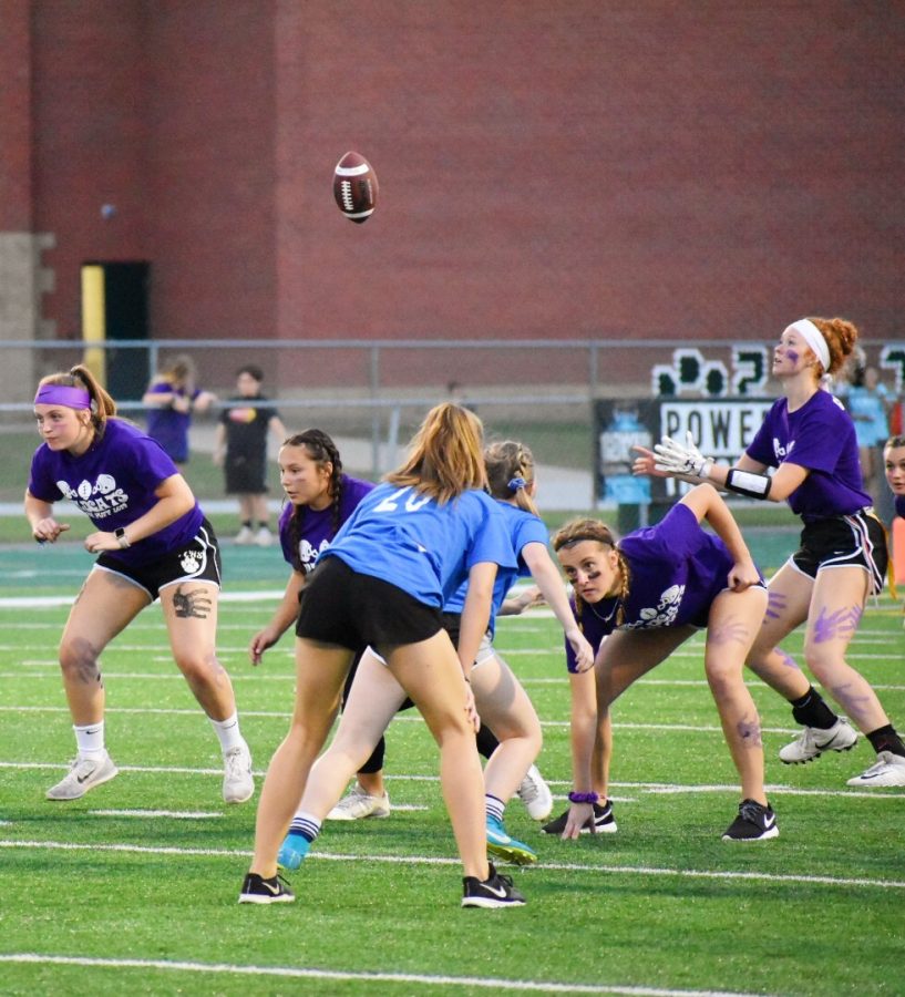 As the game begins, Melissa Schmidt, junior, runs to catch the pass from her teammate. 