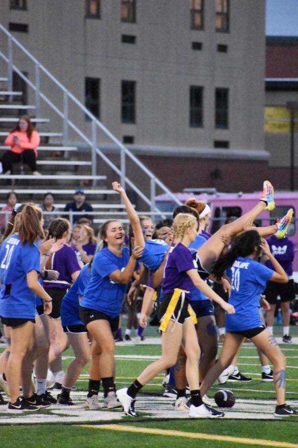 Ashley Donnell, senior, picks up fellow teammate in celebration of a completed pass as the game ended in a tie of 14-14. 