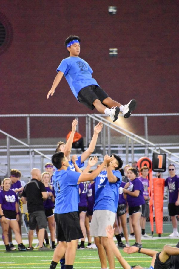 Christian DeLeon, senior, flies in the air during halftime as a stunt rehearsed by the boys. As a time for students to have fun and participate in school spirit, the boys put on a show for students, faculty, and families. 