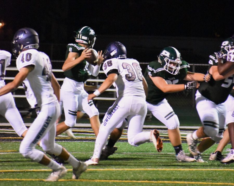 Quarterback Chris Leto (#11), junior, throws a pass to his teammates in their loss against Oswego East 7-55 on Sept. 6