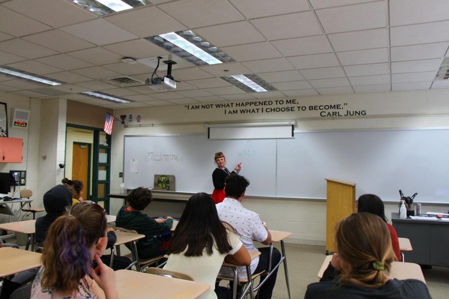 Amber Stambaugh, special education teacher, demonstrates a math problem on the board for her class.