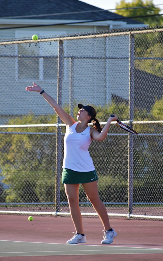 Isabel Scudella, senior, serves to her teammate at  practice. 