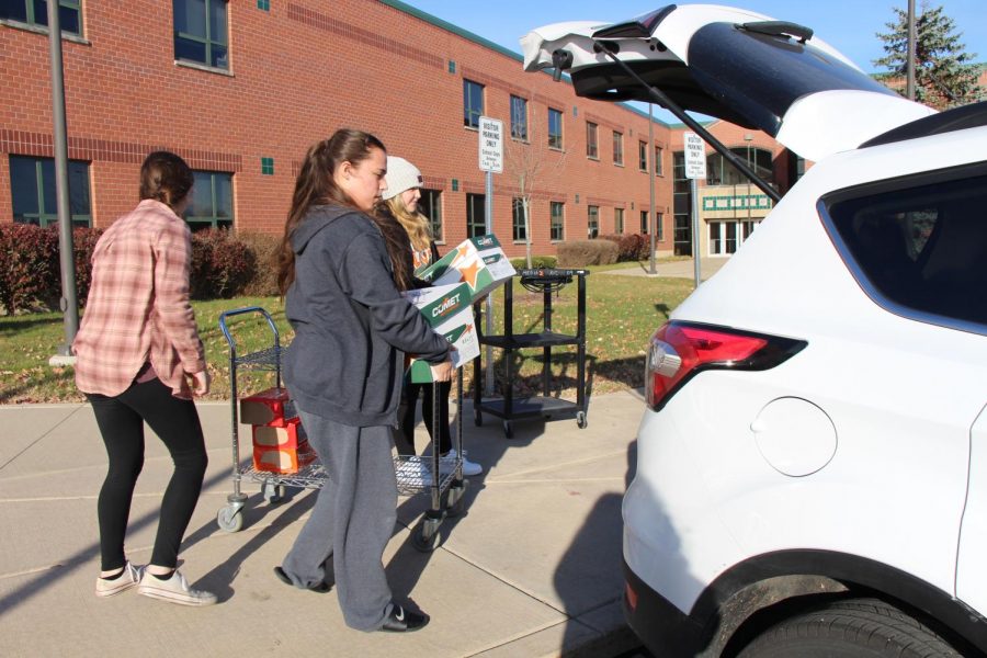 Senior Jordan Camacho , Key Club president, helps other Key Club members pack food to be delivered to the Plainfield food pantry.