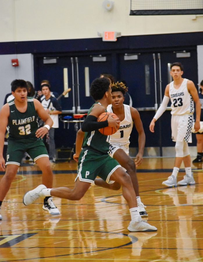 Javari Johnson, senior, dribbles past his opponents early in the game.