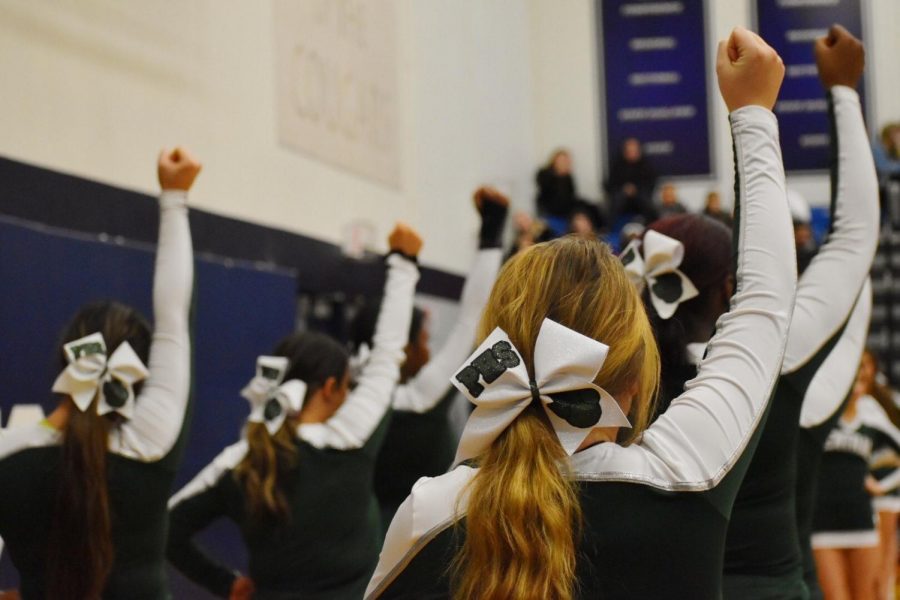Cheer could be seen wearing their white bows at the basketball game Dec 6. 