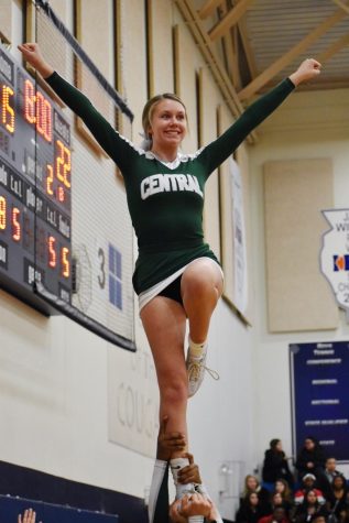 Cameron Terry, freshman, performs a liberty stunt during a timeout to cheer on the boys varsity basketball team on Friday Dec 6.