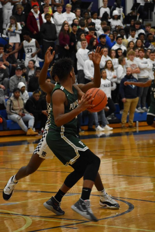 Tavari Johnson, senior, looks for an outlet pass as they retake possession.