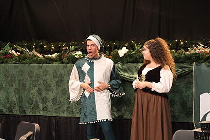 Junior Brayden Ruland, Jester, and senior Nicole Zaknoun, Wench, entertain the audience with comedic commentary. The cast performs Dec. 13 - Dec. 14 in the auditorium.