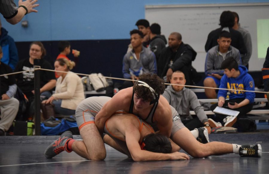 Joey Ahern, senior, pins down his Romeoville opponent at the Plainfield South meet on Jan 25. 