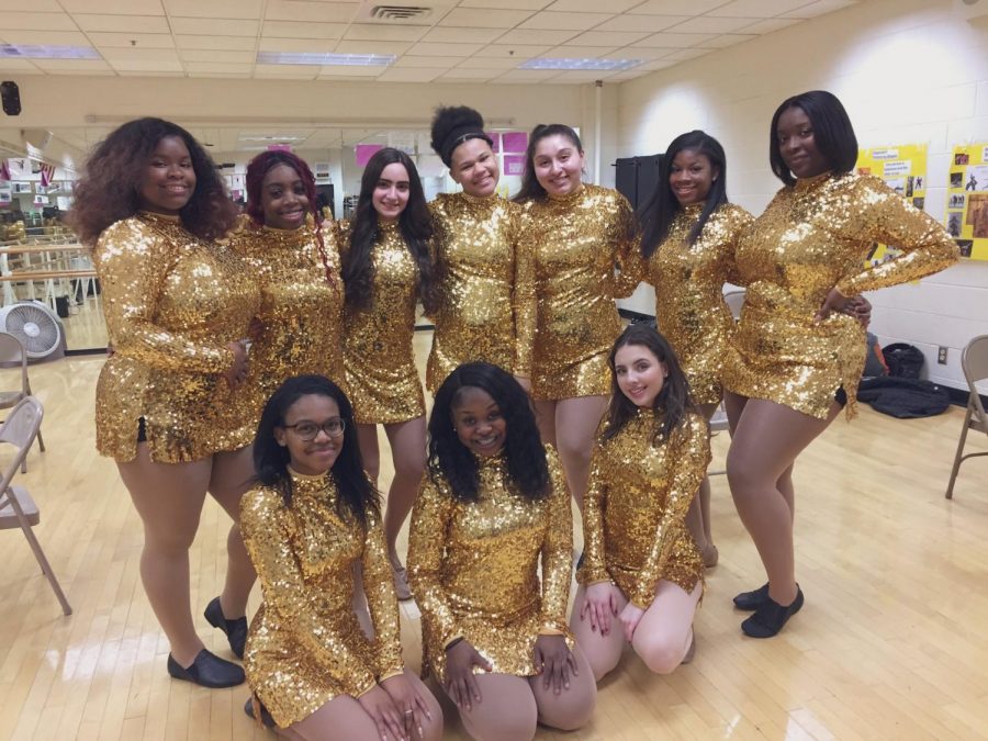 The Majorettes perform dances in various outfits in the bleachers at home basketball games.