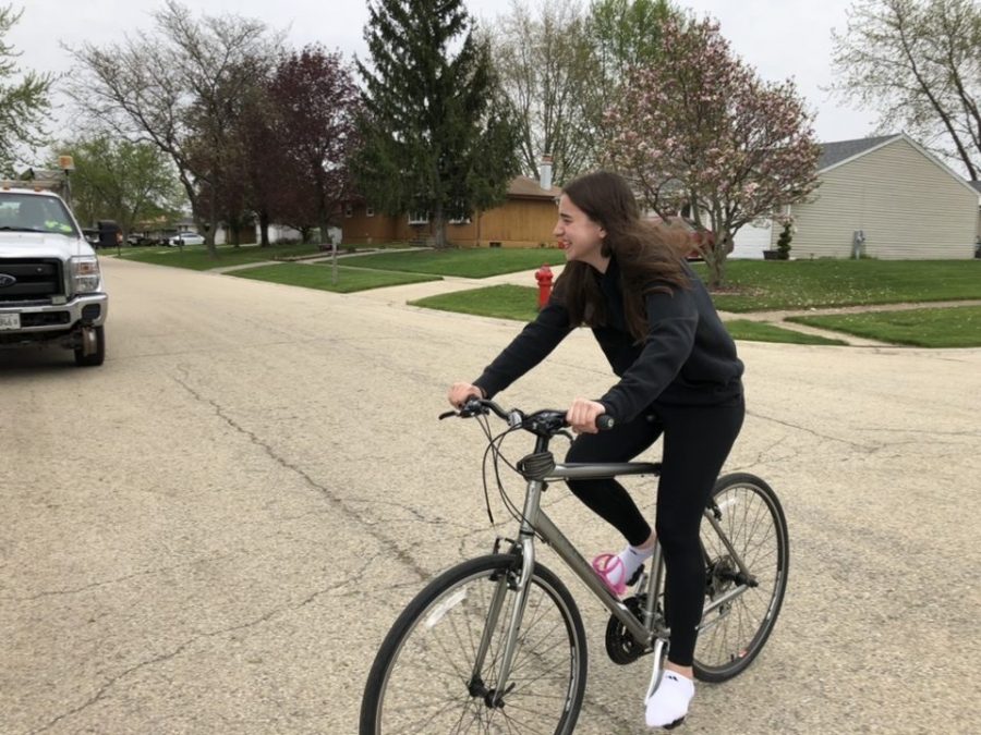 Freshman Claire Gieseke rides her bike to stay active while at home.