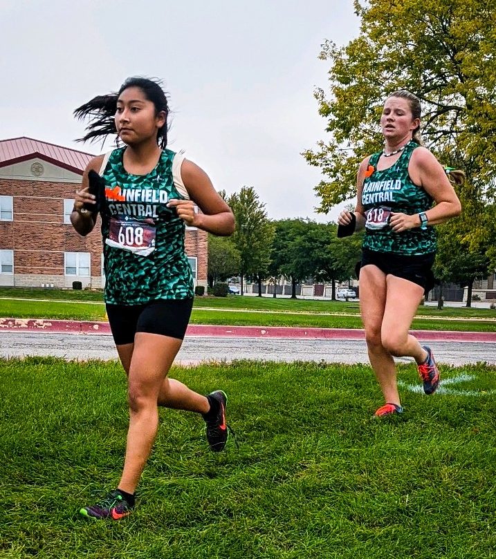 Seniors Denise Herrera-Ojeda and Lillian Pankhurst sprint off in the Open Race at Joliet West on Sept. 26.