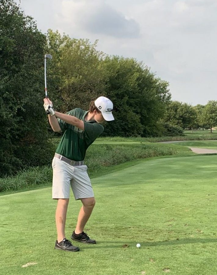 Senior Jake Ramey winds up to drive the ball down the fairway.