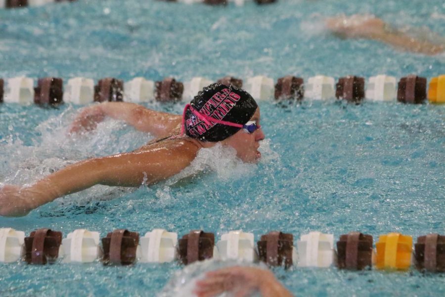 Zoi Jonihakis, junior, swims her 100 butterfly event.