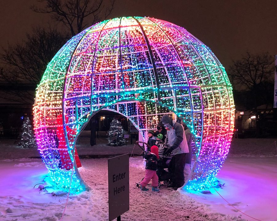 Families take photos inside the multi-colored sphere at Brookfield Zoo.