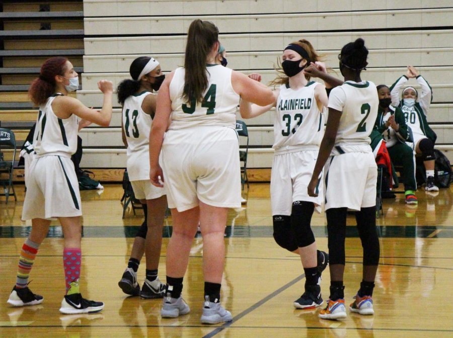 The girls varsity team comes together to chant their traditional pre-game cheer. 