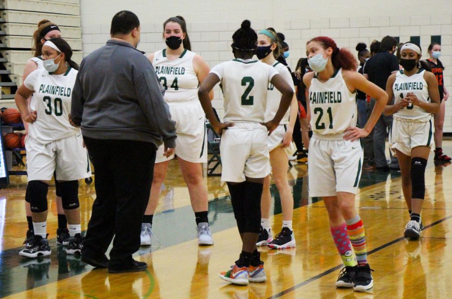 Head coach, Armond Frazier, huddles the team during halftime to strategize a plan for the second half of the game. 