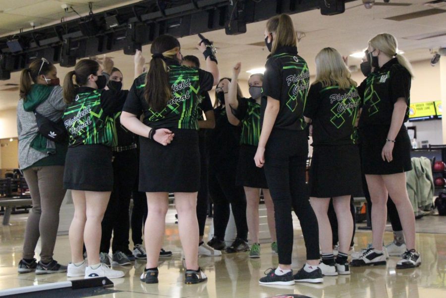 The team raises their hands shouting a cheer as they finish the meet with a score of ______.