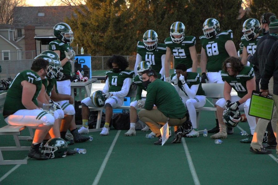 John Periro, coach, talks with his team...